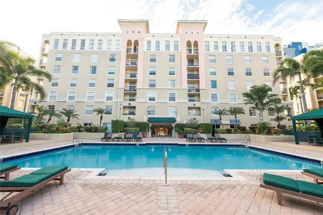 a dining room with furniture and a floor to ceiling window