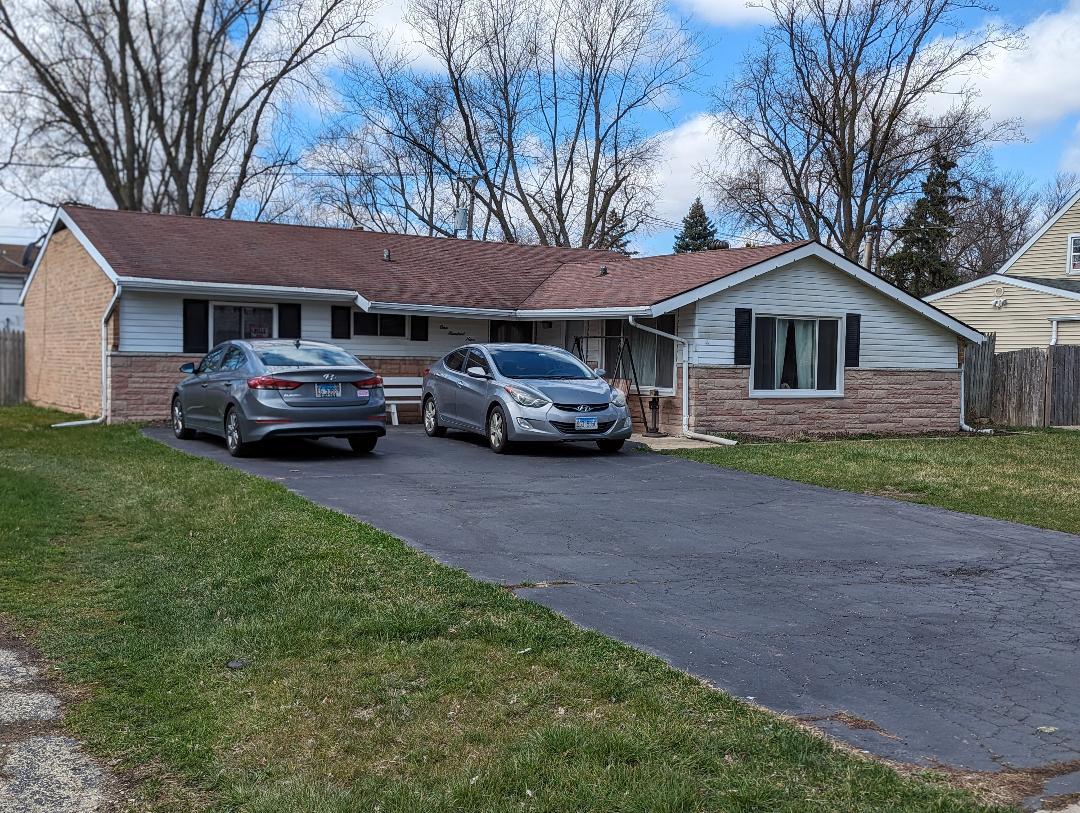 109 Queenswood Road Bolingbrook, IL 60440 - Photo 1 of 1 a car parked in front of a house with a garden