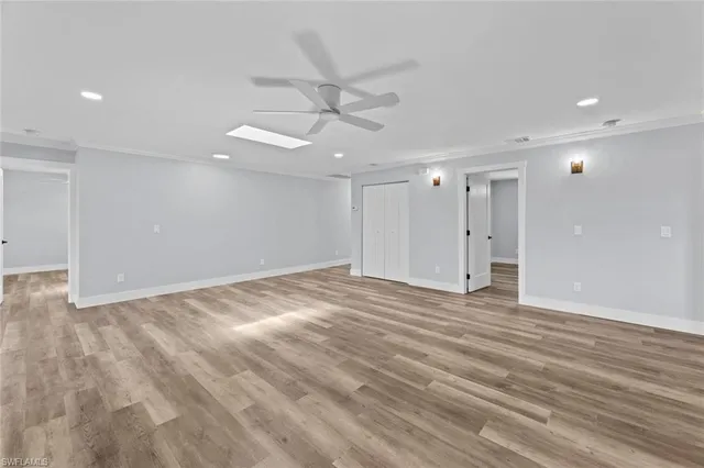 a view of an empty room with a ceiling fan