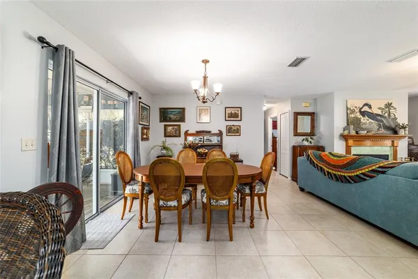 a kitchen with a stove a refrigerator and white cabinets