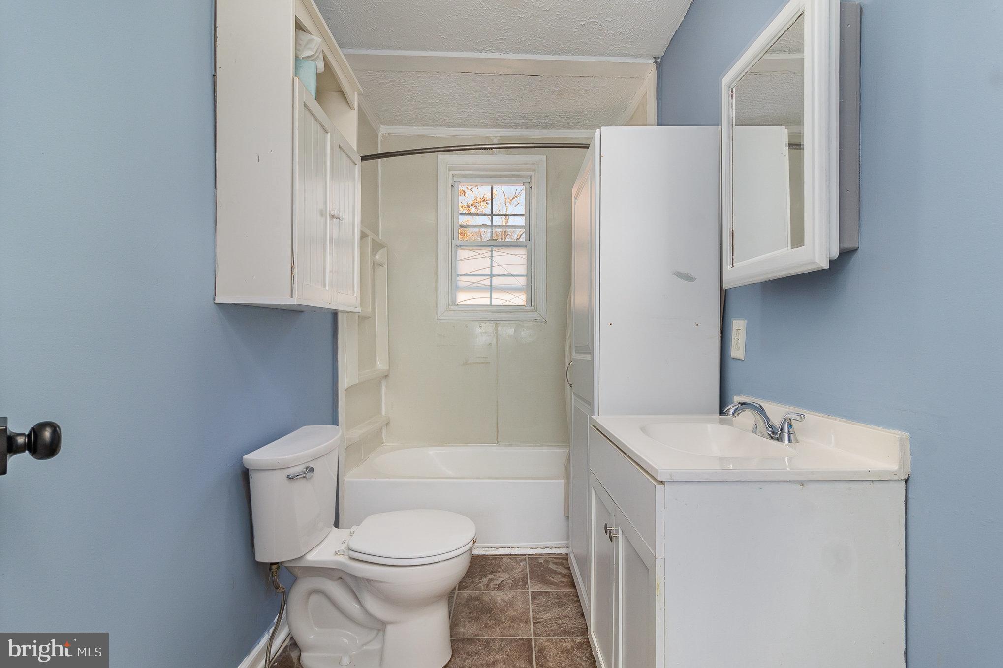 16520 Tomahawk Creek Road Orange, VA 22960 - Photo 17 of 31 a white toilet sitting next to a bathroom sink
