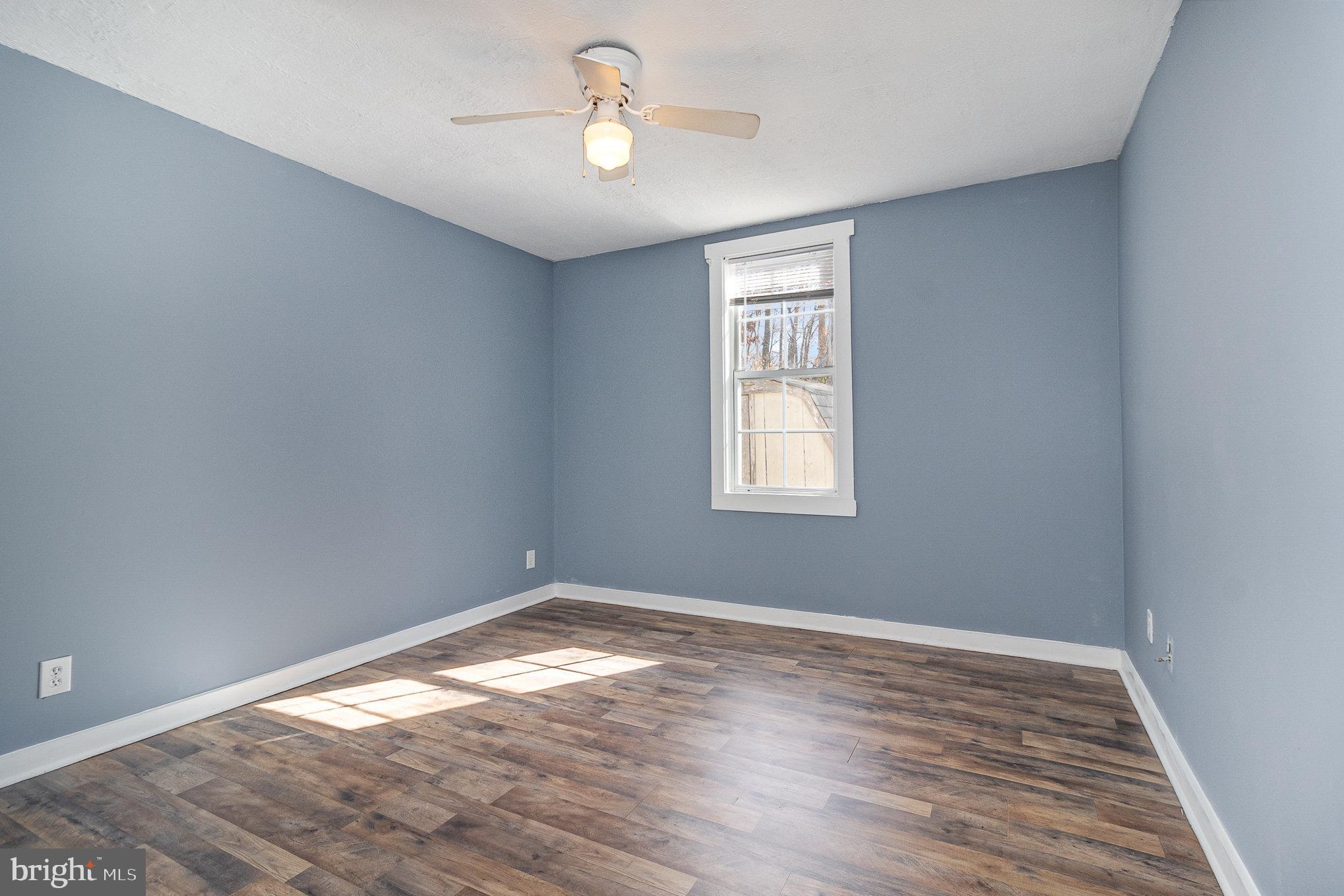 16520 Tomahawk Creek Road Orange, VA 22960 - Photo 20 of 31 a view of empty room with wooden floor and fan