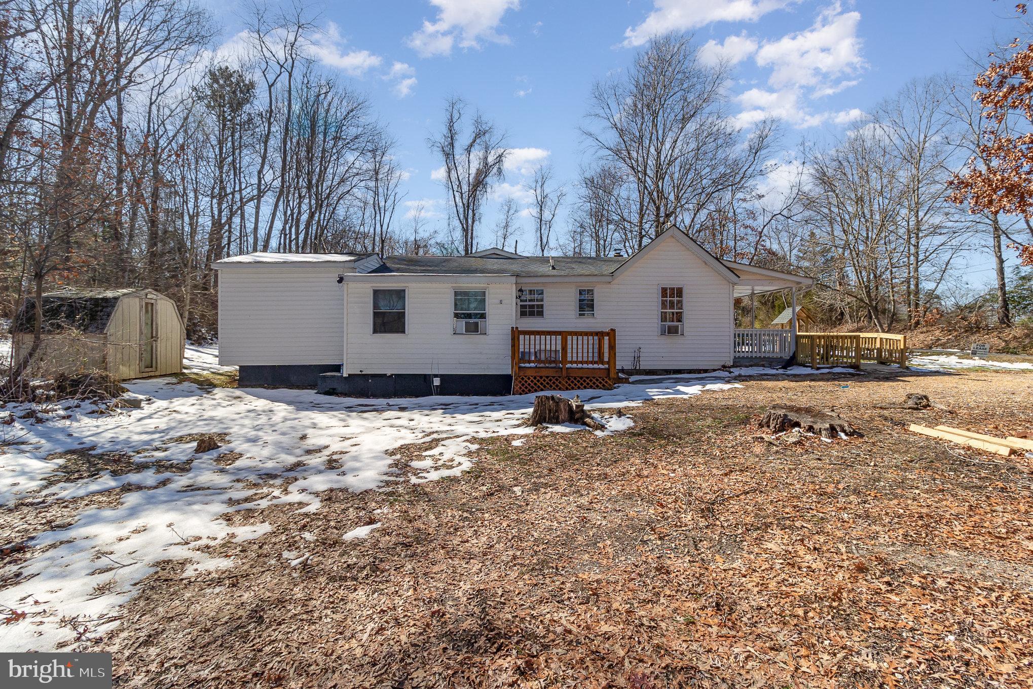 16520 Tomahawk Creek Road Orange, VA 22960 - Photo 28 of 31 a view of a white house with a yard covered in snow