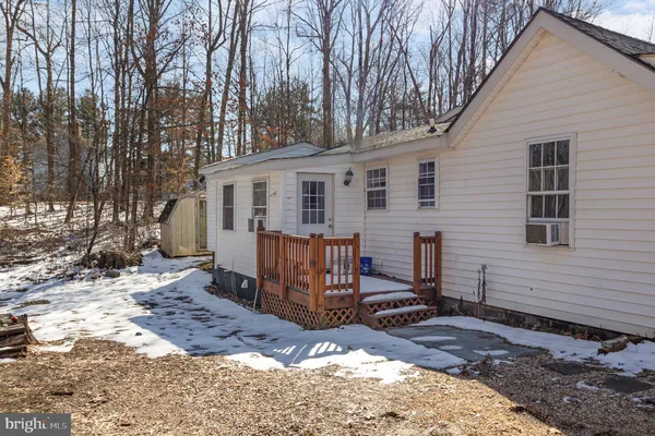 a view of a house with a yard covered in snow
