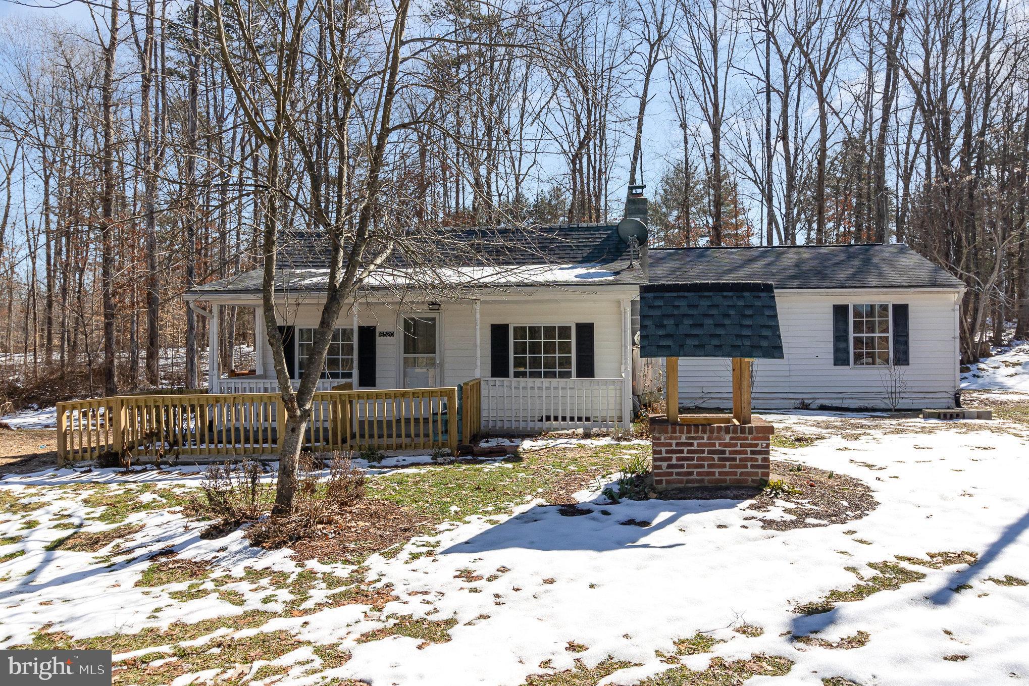 16520 Tomahawk Creek Road Orange, VA 22960 - Photo 7 of 31 a front view of a house with a yard covered with snow and trees