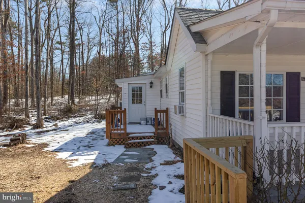 a view of two chairs in the patio