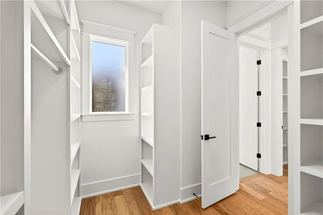 a view of a room with a window and a ceiling fan