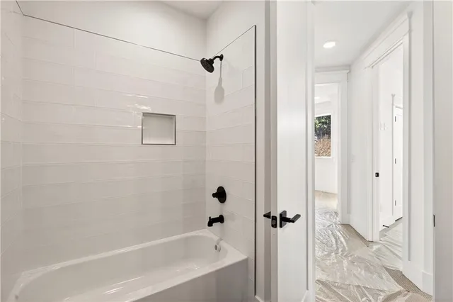 a kitchen with stainless steel appliances white cabinets and wooden floor