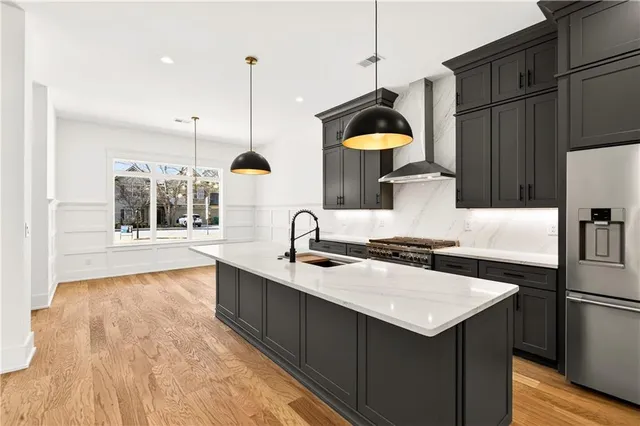 a kitchen with a sink a counter top space and stainless steel appliances