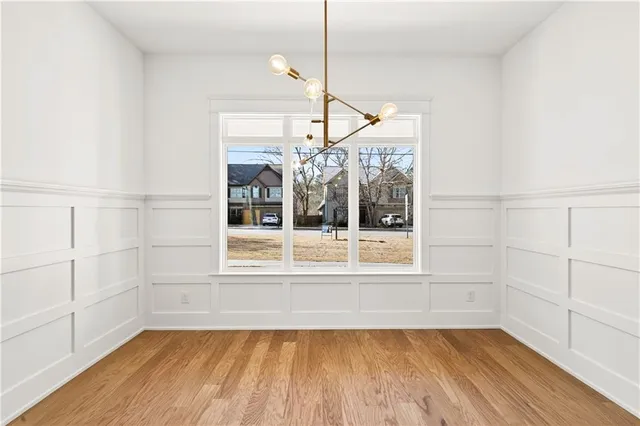 a view of a room with wooden floor and cabinet