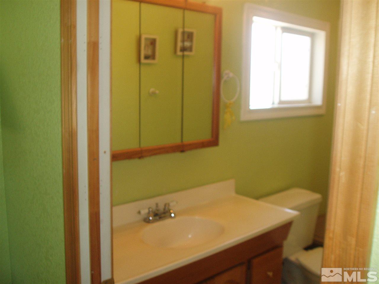 17570 Fantail Street Reno, NV 89508 - Photo 8 of 22 a bathroom with a sink and a mirror