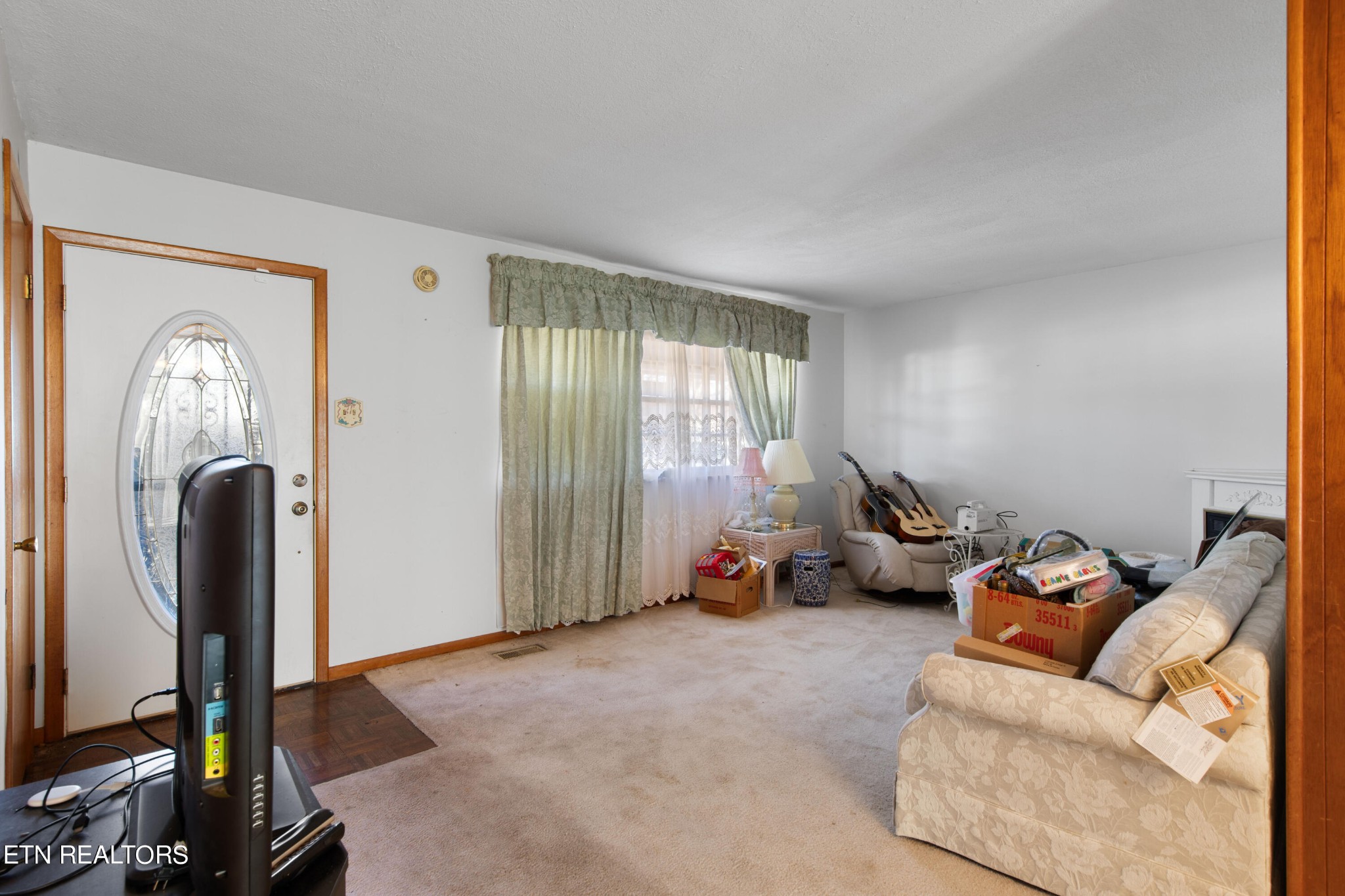 129 Peterson Road Knoxville, TN 37934 - Photo 16 of 24 a living room with furniture gym equipment and a large window