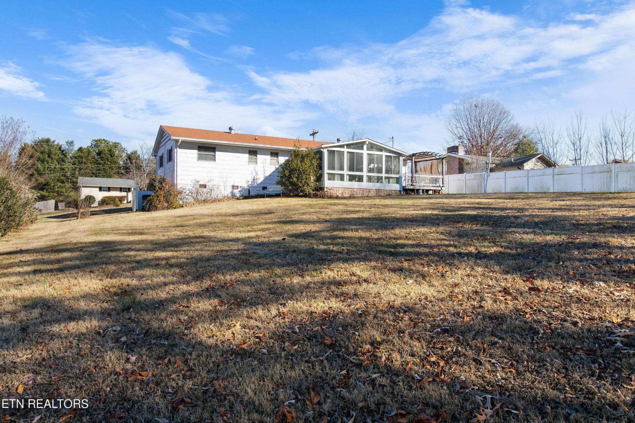 129 Peterson Road Knoxville, TN 37934 - Photo 22 of 24 a view of a big house with a big yard and large trees
