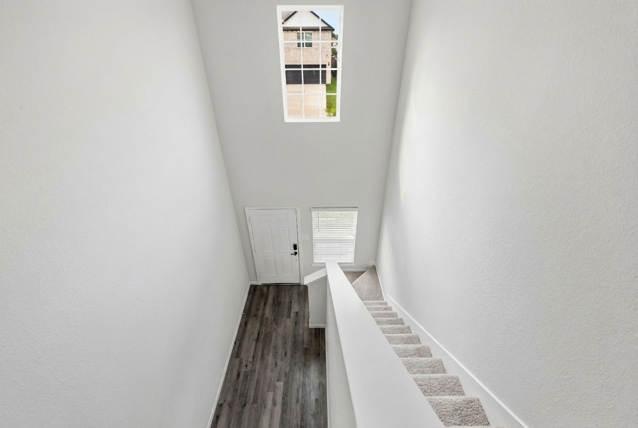 5018 Yello Ginko Trail Spring, TX 77373 - Photo 13 of 24 Second-floor view of the foyer and staircase, highlighted by soaring 20-foot ceilings.