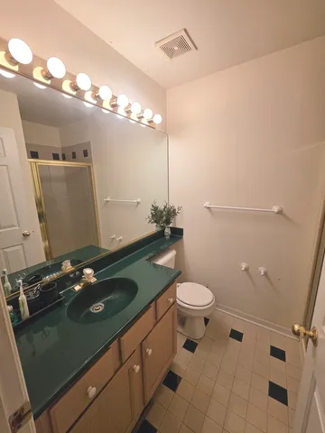 a bathroom with a glass shower door
