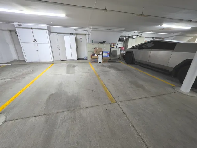a living room with furniture a flat screen tv and a large window