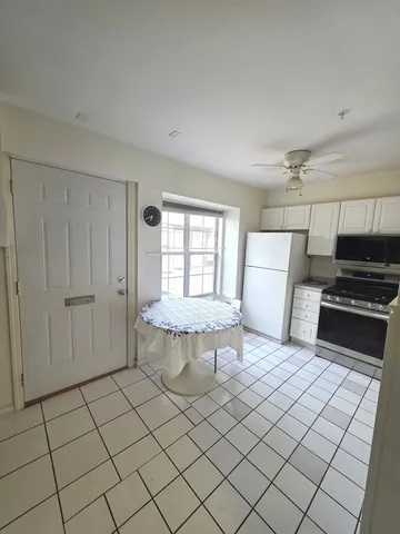 a kitchen with a stove a refrigerator and a sink