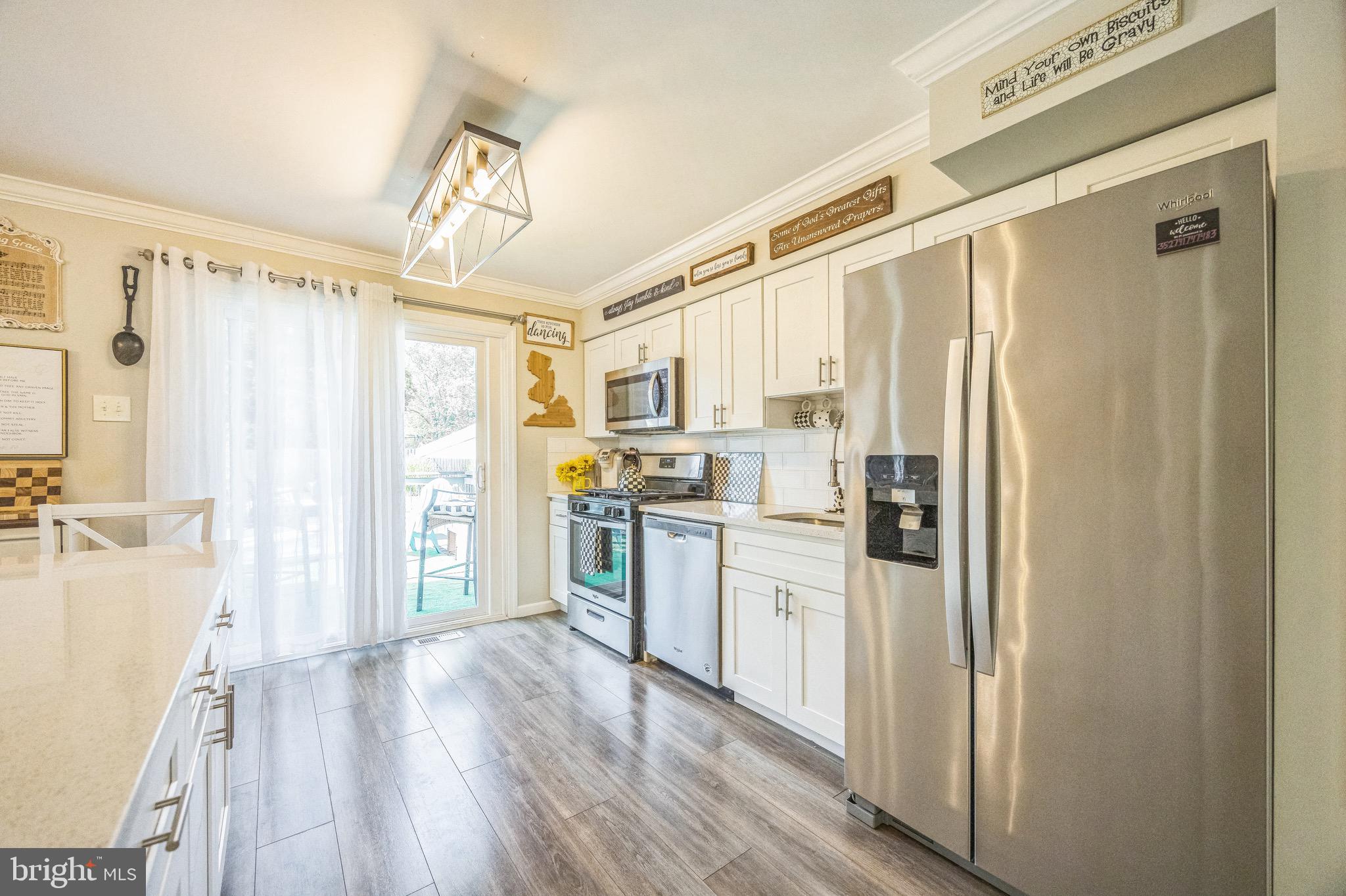 333 Farmdale Road Moorestown, NJ 08057 - Photo 13 of 45 a kitchen with stainless steel appliances a refrigerator and a stove top oven