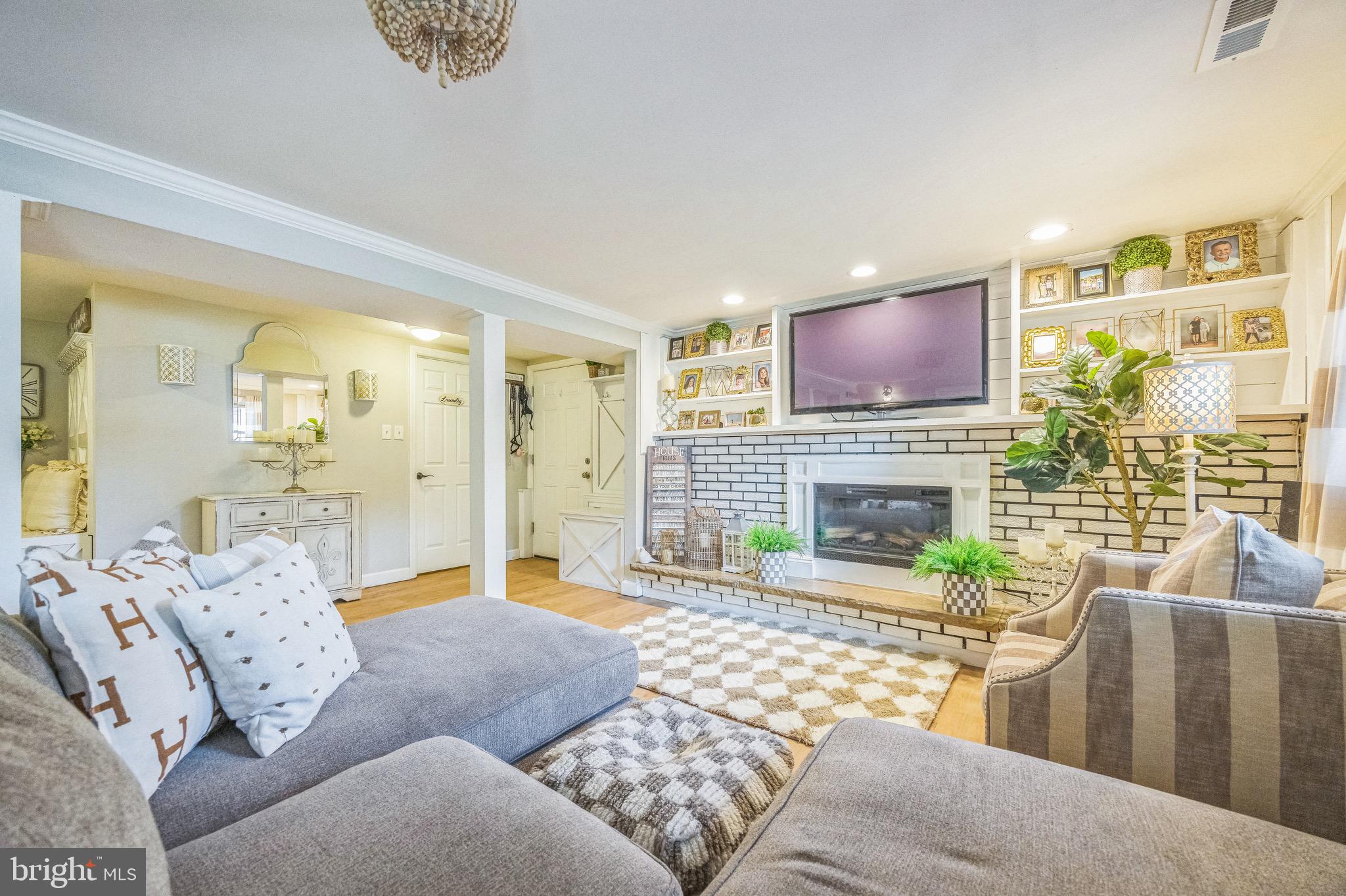 333 Farmdale Road Moorestown, NJ 08057 - Photo 31 of 45 a living room with furniture a fireplace and a flat screen tv