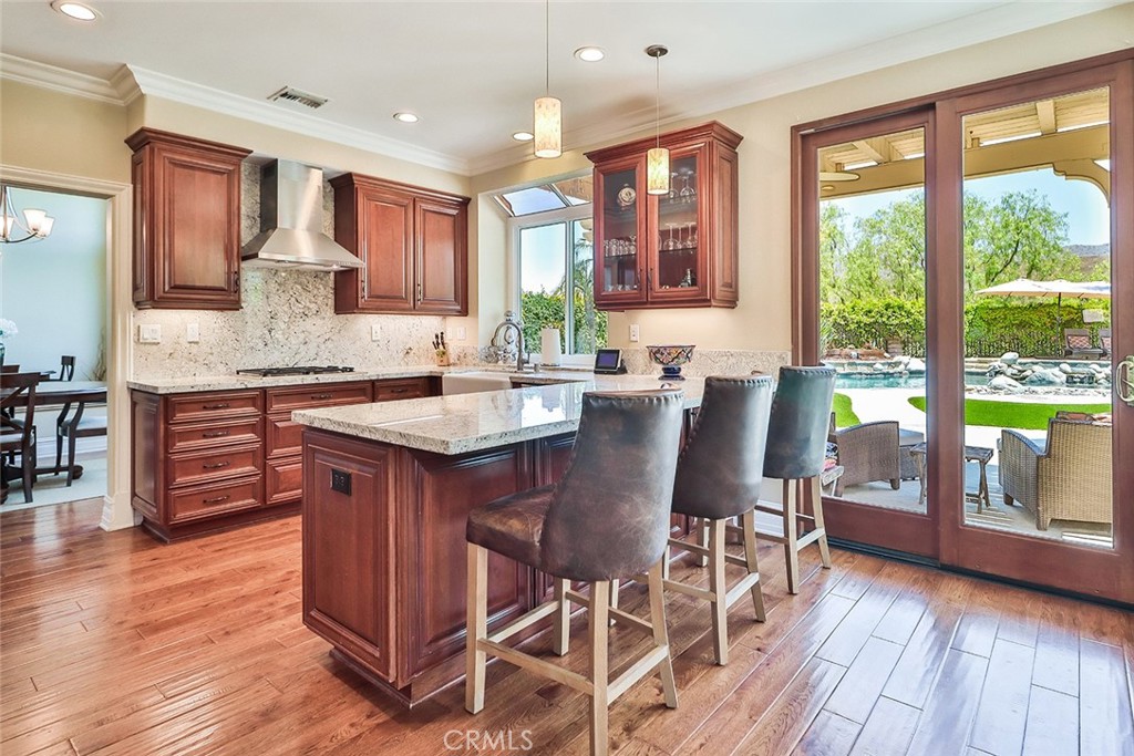 5205 Pesto Way Oak Park, CA 91377 - Photo 19 of 71 a kitchen with stainless steel appliances granite countertop wooden floor window and cabinets