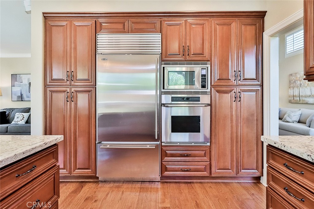 5205 Pesto Way Oak Park, CA 91377 - Photo 24 of 71 a kitchen with stainless steel appliances granite countertop a refrigerator and a stove top oven