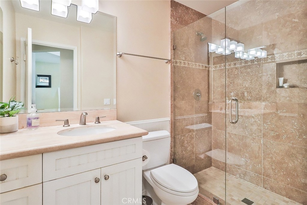5205 Pesto Way Oak Park, CA 91377 - Photo 29 of 71 a bathroom with a sink toilet a mirror and shower