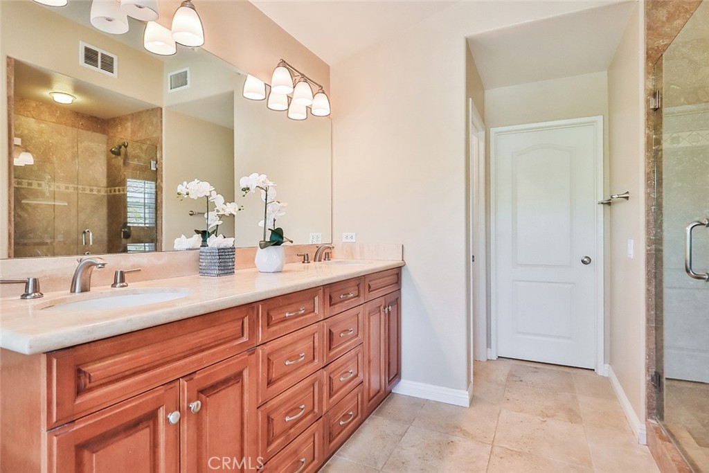 5205 Pesto Way Oak Park, CA 91377 - Photo 36 of 71 a bathroom with a double vanity sink and a mirror