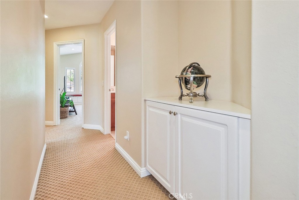 5205 Pesto Way Oak Park, CA 91377 - Photo 44 of 71 a view of a hallway to a room with wooden floor and mirror