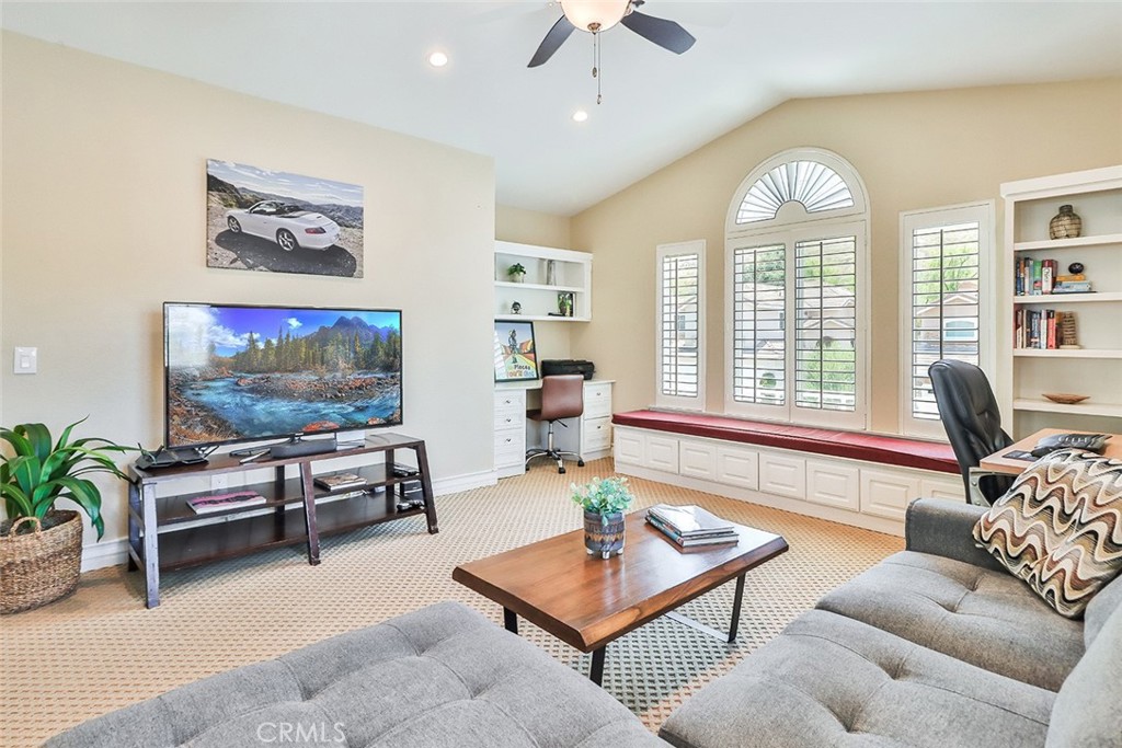 5205 Pesto Way Oak Park, CA 91377 - Photo 46 of 71 a living room with furniture a large window and a flat screen tv