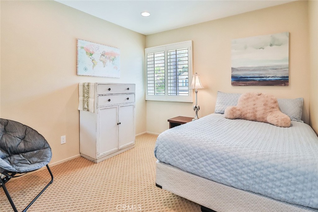 5205 Pesto Way Oak Park, CA 91377 - Photo 50 of 71 a bedroom with a bed and a couch