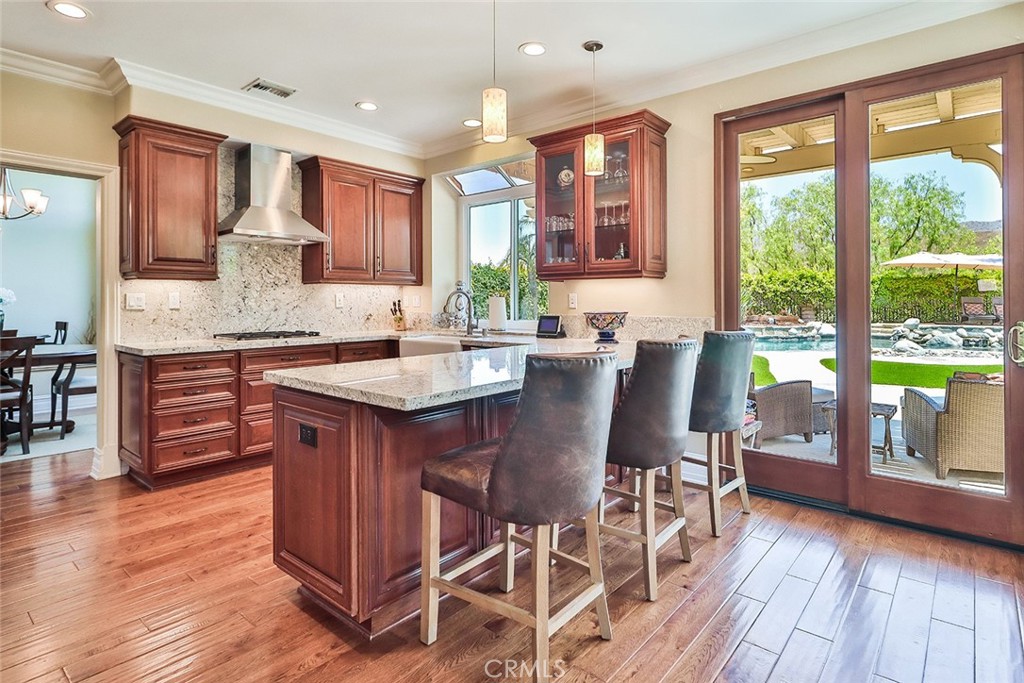 5205 Pesto Way Oak Park, CA 91377 - Photo 5 of 71 a kitchen with stainless steel appliances granite countertop wooden floor window and cabinets