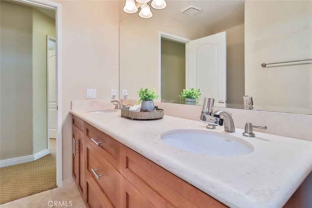 5205 Pesto Way Oak Park, CA 91377 - Photo 52 of 71 a bathroom with double vanity sinks and a mirror