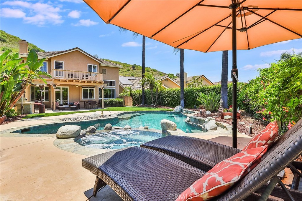5205 Pesto Way Oak Park, CA 91377 - Photo 59 of 71 a view of a patio with a table and chairs under an umbrella