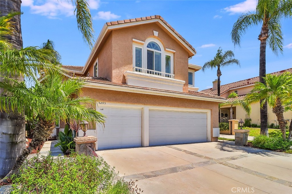 5205 Pesto Way Oak Park, CA 91377 - Photo 6 of 71 a front view of a house with a yard and garage