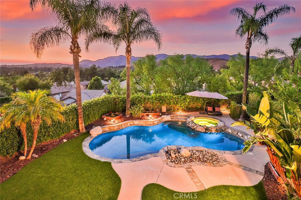 5205 Pesto Way Oak Park, CA 91377 - Photo 62 of 71 a view of a swimming pool with a table and chairs
