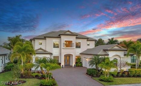 2235 Somerset Place Naples, FL 34120 - Photo 1 of 49 a front view of a house with garden