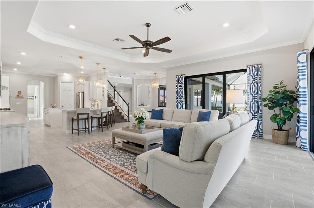 2235 Somerset Place Naples, FL 34120 - Photo 12 of 49 a living room with furniture and a wooden floor
