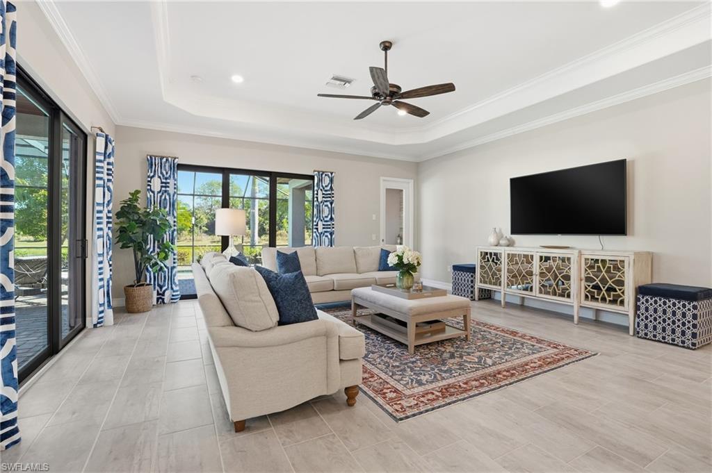 2235 Somerset Place Naples, FL 34120 - Photo 13 of 49 a living room with furniture and a flat screen tv