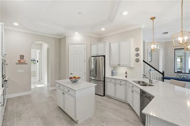 a kitchen with stainless steel appliances a stove a refrigerator and cabinets