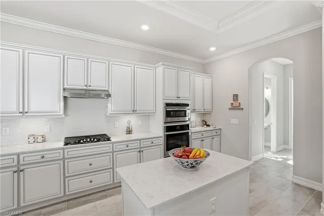 a kitchen with stainless steel appliances a stove sink microwave and cabinets