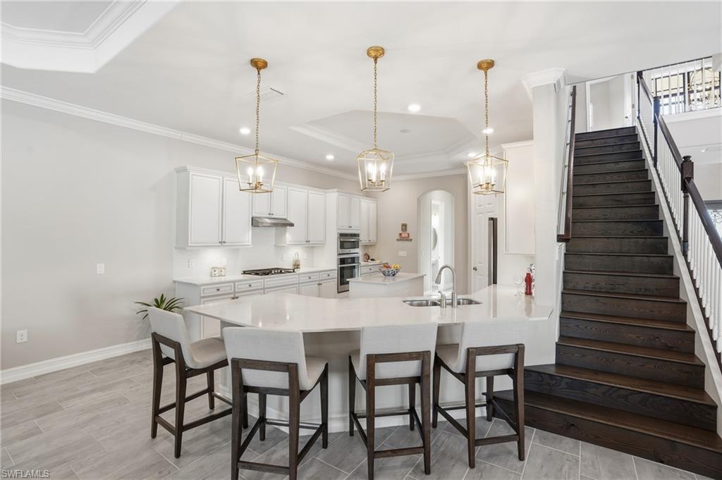 2235 Somerset Place Naples, FL 34120 - Photo 15 of 49 a dining room with furniture and wooden floor