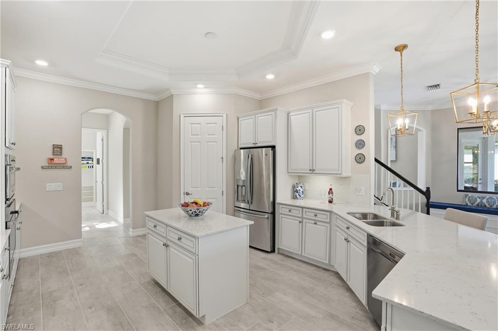 2235 Somerset Place Naples, FL 34120 - Photo 16 of 49 a kitchen with a sink stove and refrigerator