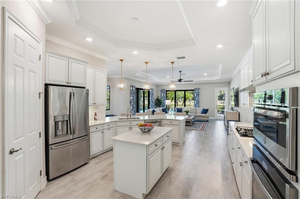 2235 Somerset Place Naples, FL 34120 - Photo 49 of 49 a kitchen with a sink stainless steel appliances and counter space