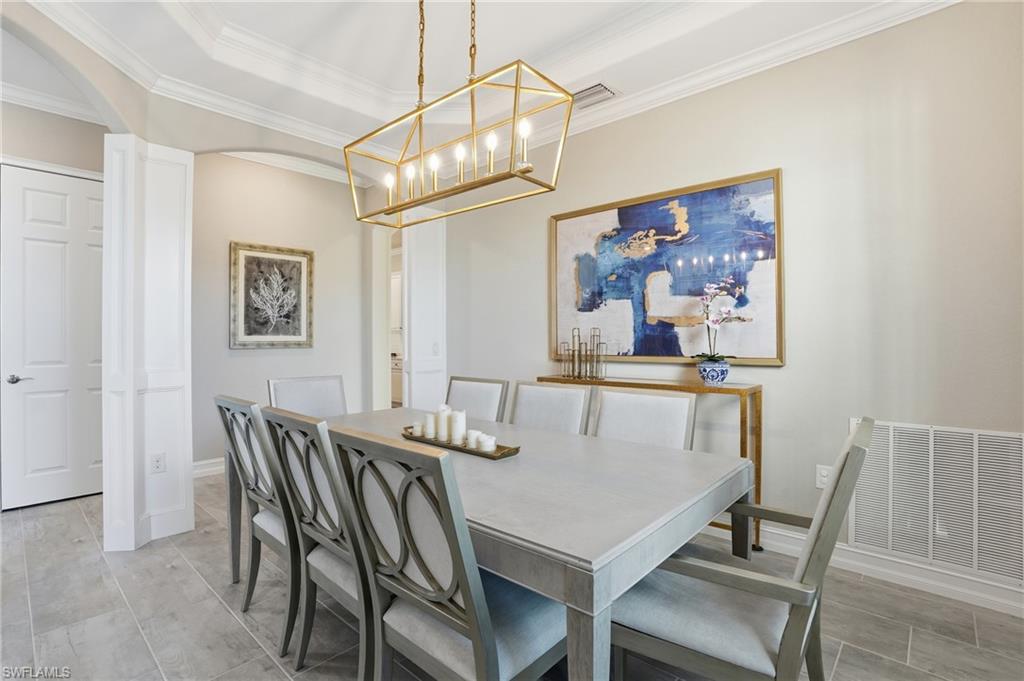 2235 Somerset Place Naples, FL 34120 - Photo 17 of 49 a view of a dining room with furniture and a chandelier
