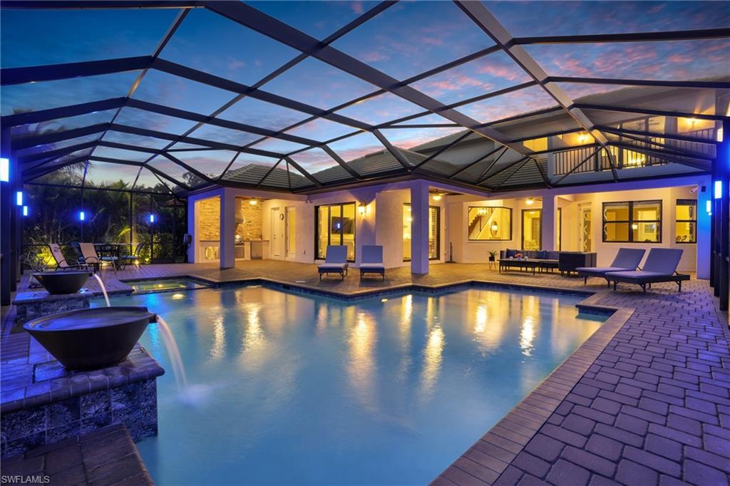 2235 Somerset Place Naples, FL 34120 - Photo 2 of 49 a view of swimming pool with sitting area