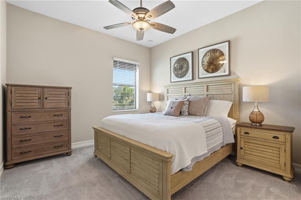 2235 Somerset Place Naples, FL 34120 - Photo 24 of 49 a bedroom with a bed and a dresser
