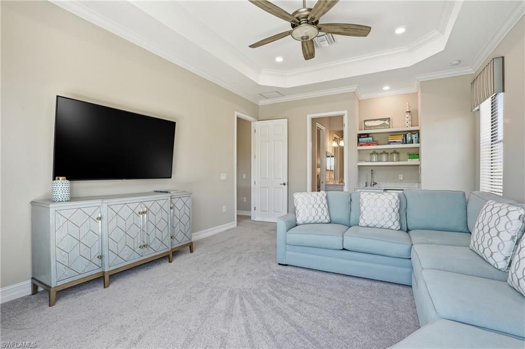 2235 Somerset Place Naples, FL 34120 - Photo 26 of 49 a living room with furniture and a flat screen tv