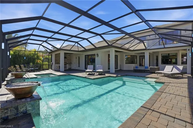 a view of a backyard with sitting area and tub