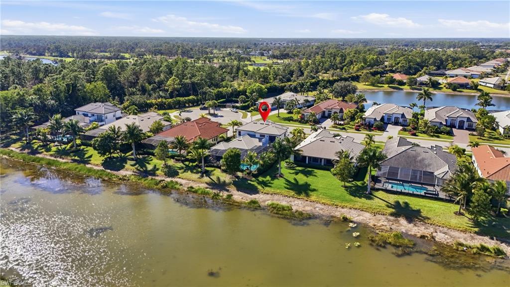 2235 Somerset Place Naples, FL 34120 - Photo 40 of 49 an aerial view of a houses with a lake view