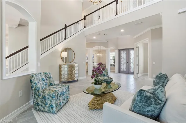 a living room with furniture a flat screen tv and a rug